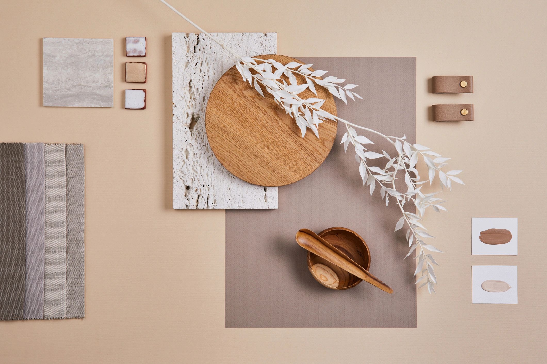 An arrangement of natural materials including wood, stone, and fabric, showcasing a minimalist aesthetic.